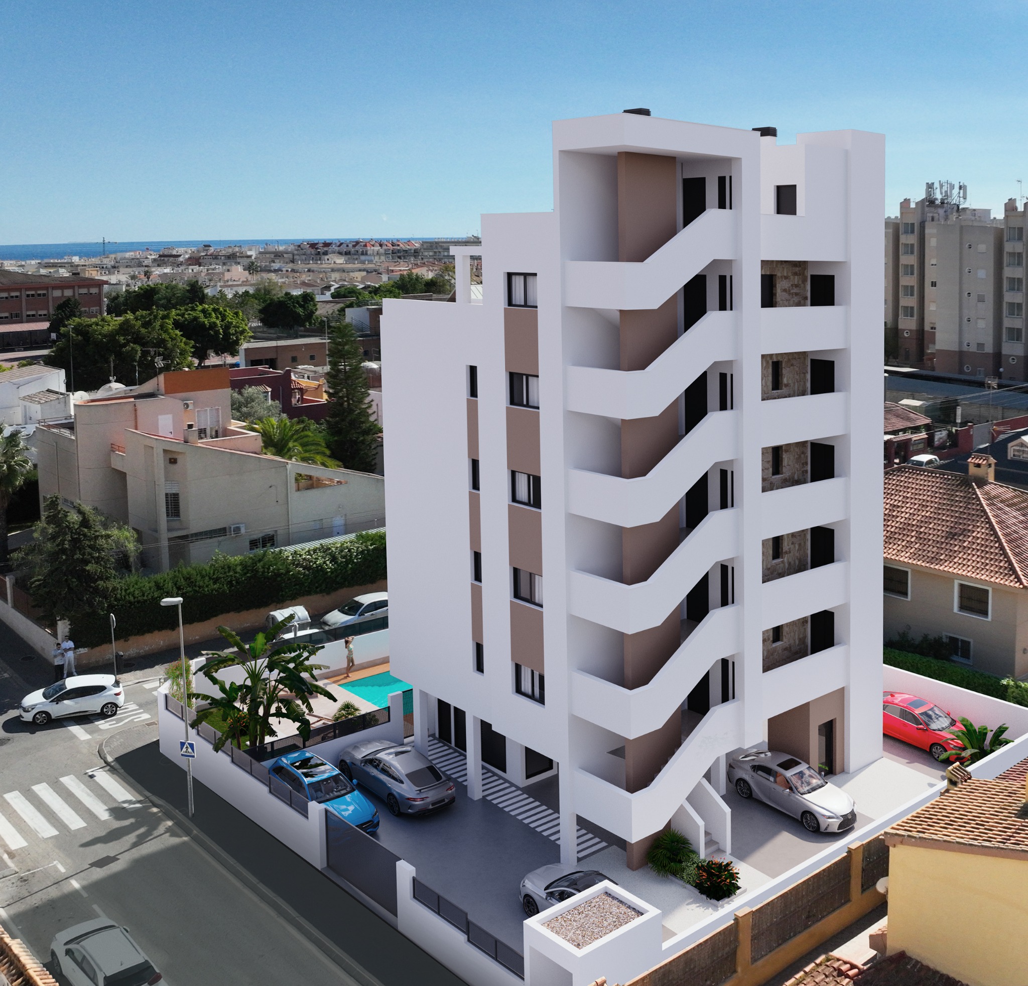 Vista trasera del edificio con zona de aparcamiento